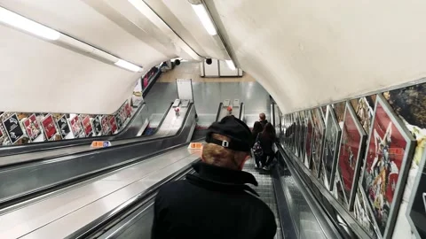 Passengers descending escalator to a Picadilly line subway metro train station Stock Footage 226768338