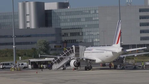 Passengers disembark plane using boarding stairs then board airport bus v2 Stock Footage 119830476