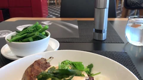Passengers eating roasted duck and green beans at airport restaurant Video stock 295943953