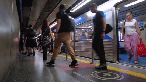 Passengers enter and exit for the train to arrive on the platform of blue line 1 Stock Footage 252626207