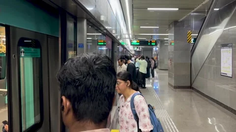 Passengers Entering Crowded Metro Train at Busy Station Platform Video stock 347023732