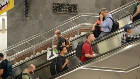 Passengers on an escalator at a train station. Stock Footage 318373304