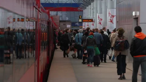 Passengers get off the commuter train at the station. Stock Footage 228639932