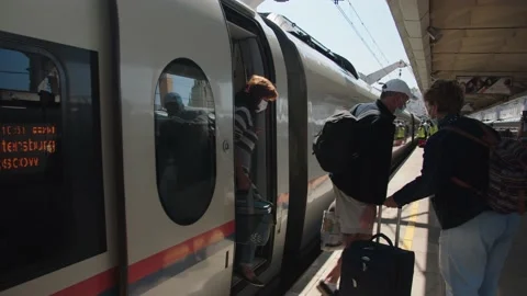 Passengers get off the long-distance train on the platform. summer day Stock Footage 199521240