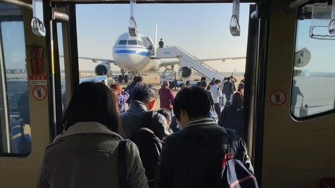 Passengers get off the shuttle to board Stock Footage 121003584