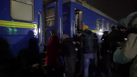  passengers get on the train car. the conductor checks the boarding tickets.  Video stock 143871735
