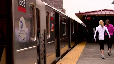 Passengers getting off NYC MTA Subway on elevated outdoor platform Stock Footage 49223890