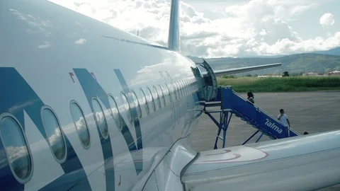 Passengers getting on the Plane using the Flight Ladder. Wide Angle Stock Footage 87777953