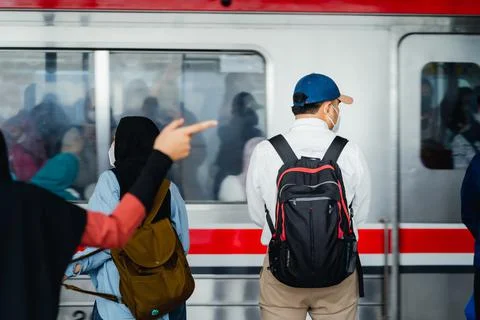 Passengers getting ready to enter the KRL commuter line at manggarai station Stock Photos