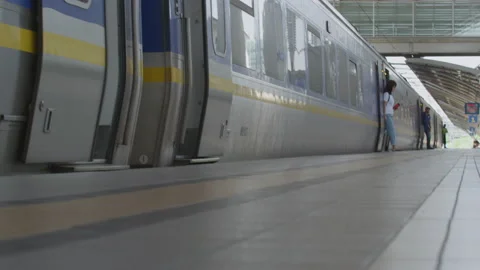 Passengers getting off the train at the railway station, Malaysia Stock Footage 134738971