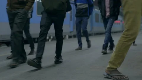 Passengers going to catch a train on a railway platform at night time Stock Footage 228197144