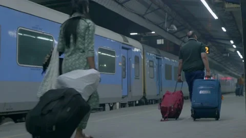 Passengers going to catch the train on a railway platform india Stock Footage 228197276