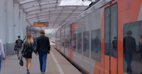 Passengers got out the train and walk along the platform of the metro station Stock Footage 119632513