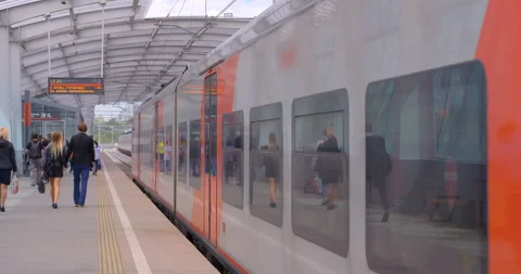 Passengers got out the train and walk along the platform of the metro station  Stock Footage 119632720