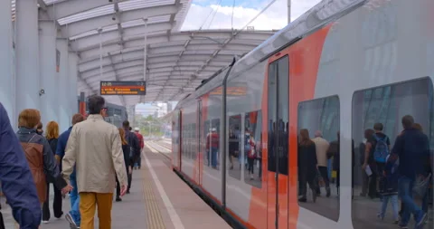 Passengers got out the train and walk along the platform of the metro station Stock Footage 119632873