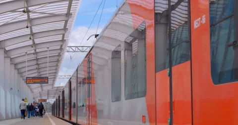 Passengers got out the train and walk along the platform of the metro station  Stock Footage 119633904