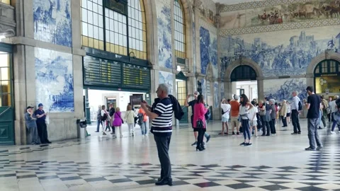 Passengers at the historical Sao Bento train station in Porto, Portugal - 4K Stock Footage 107316432