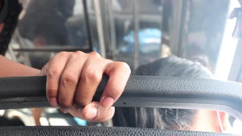 Passengers hold on to the handrails while riding a city bus Stock Footage 255389163
