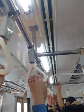 Passengers Holding Handrails Inside Crowded KRL Commuter Train Stock Photos
