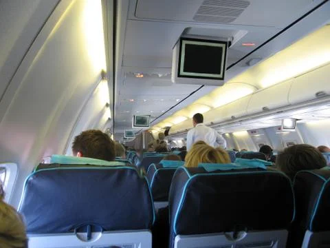 Passengers inside airplane Stock Photos