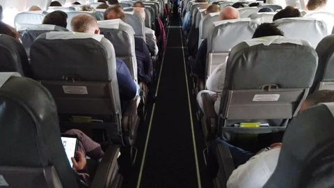Passengers inside the plane. Economy class interior. Stock Footage 122923109