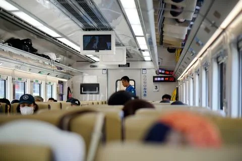 Passengers inside a train car during a journey in Bandung, West Java, Indonesia Fotos de archivo