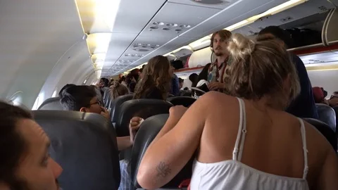 Passengers  leave the plane cabin . The plane flew from Bangkok to Singapore Video stock 112945171