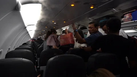 Passengers leave the plane cabin. The plane flew from Singapore to Kuala Lumpur Stock Footage 114104563