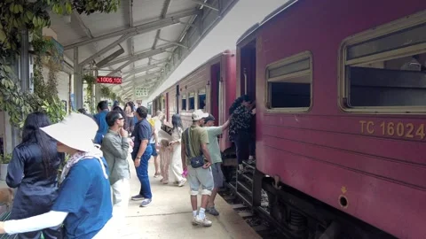 Passengers leaving and boarding the train at the Ella railway station Stock Footage 315337057