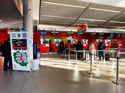Passengers line up at Ryanair checkin counters at Warsaw Modlin Airport in .. Stock Photos