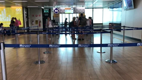 Passengers lined up for boarding at the gate provide documents to hostesses. Stock Footage 94139254