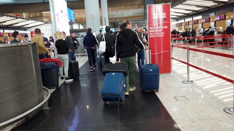 Passengers lined up at Turkish Airlines counters to check in Stock Footage 128203463