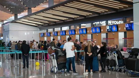 Passengers lined up at Turkish Airlines counters to check in Istanbul Airport Stock Photos