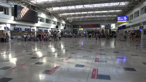 Passengers in the lines for flight registration and social distancing marks  Stock Footage 136892150