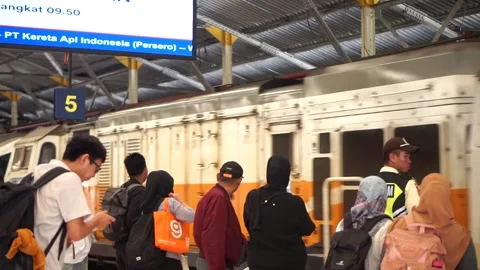 Passengers lining up at the Bandung Station platform underneath a digital rail Stockbeeldmateriaal 337858295