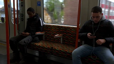 Passengers on a London Overground train. Stock Footage 165984398