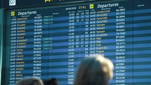 Passengers looking at timetable board screen at the airport, international Stock Footage 97143261