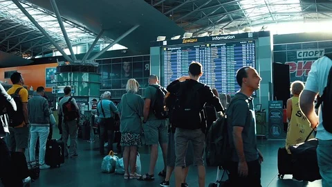 Passengers looking at timetable board screen at the airport, international Stock Footage 97143344