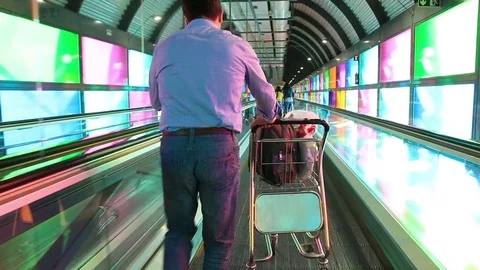 Passengers with luggage going to the gate at a modern Station, airport terminal Stock Footage 75131322