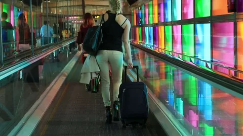 Passengers with luggage going to the gate at a modern Station, airport terminal 動画素材 75131371