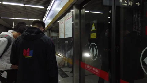Passengers with masks getting on train in subway, Beijing, China, hyper lapse Stock Footage 141291086