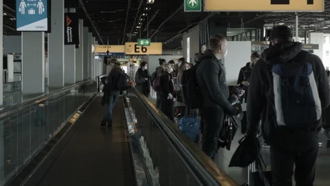 Passengers mostly Wearing Mask Lining Up At Airport Dolly Shot Down Travelator Stock Footage 127799479