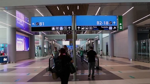 Passengers moving on the moving walkway inside the new international  airport Stock Footage 117155033