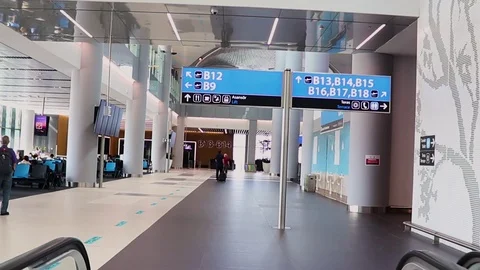 Passengers moving on the moving walkway inside the new international airport Stock Footage 117165910