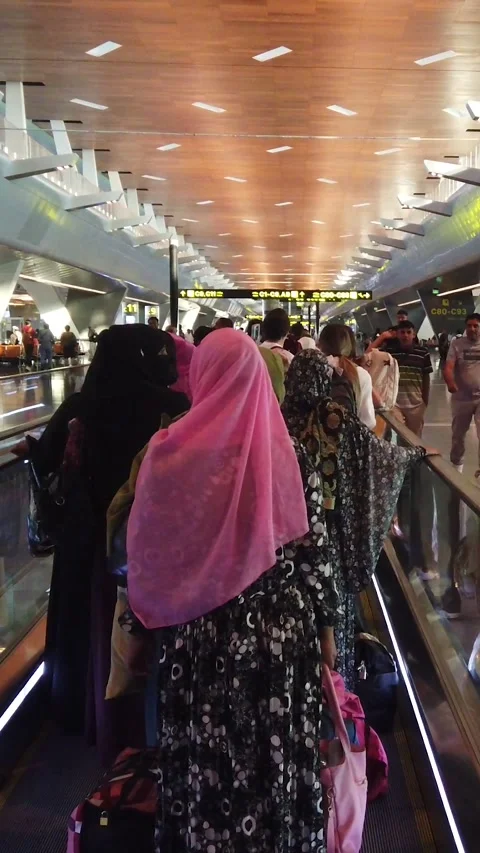 Passengers on Moving Walkway in Busy Doha Airport Terminal with Modern Design Stock Footage 340766852