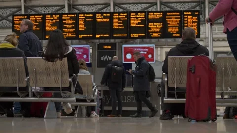Passengers at Paddington station waiting for platform info slow motion 4K Stock Footage 201322680