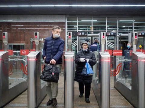 Passengers pass through automatic turnstiles at the Moscow metro station. Stock Photos