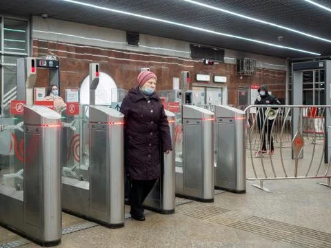 Passengers pass through automatic turnstiles at the Moscow metro station. Stock Photos