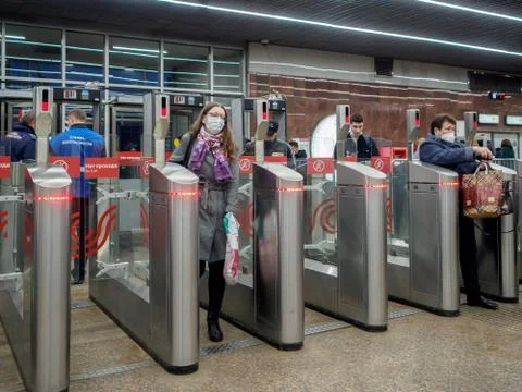 Passengers pass through automatic turnstiles at the Moscow metro station. Stock Photos