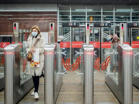 Passengers pass through automatic turnstiles at the Moscow metro station. Stock Photos